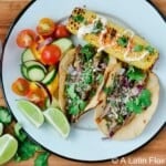 chimichurri steak tacos served with corn on the cob and salad