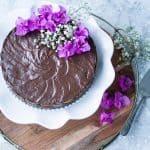 Chocolate marquesa (marquesa de chocolate) on white cake stand decorated with Bougainvillea flowers