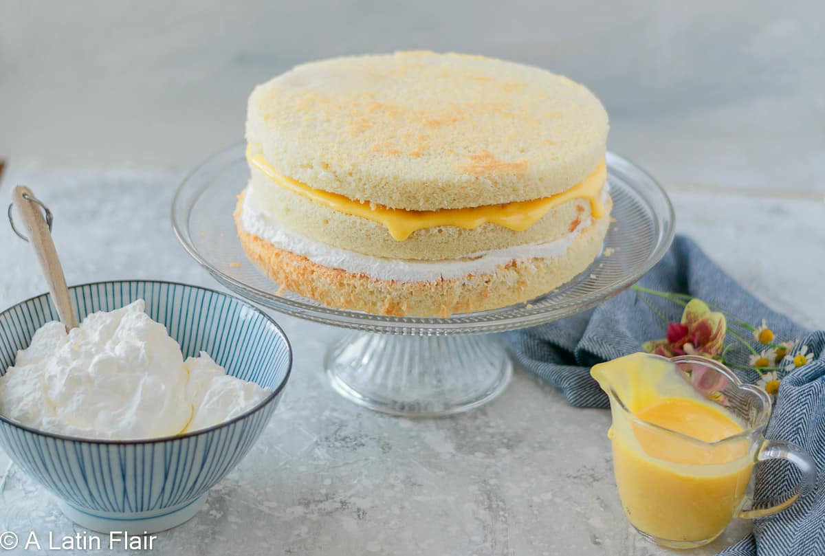 coconut cake layered with whipped cream and passion fruit curd
