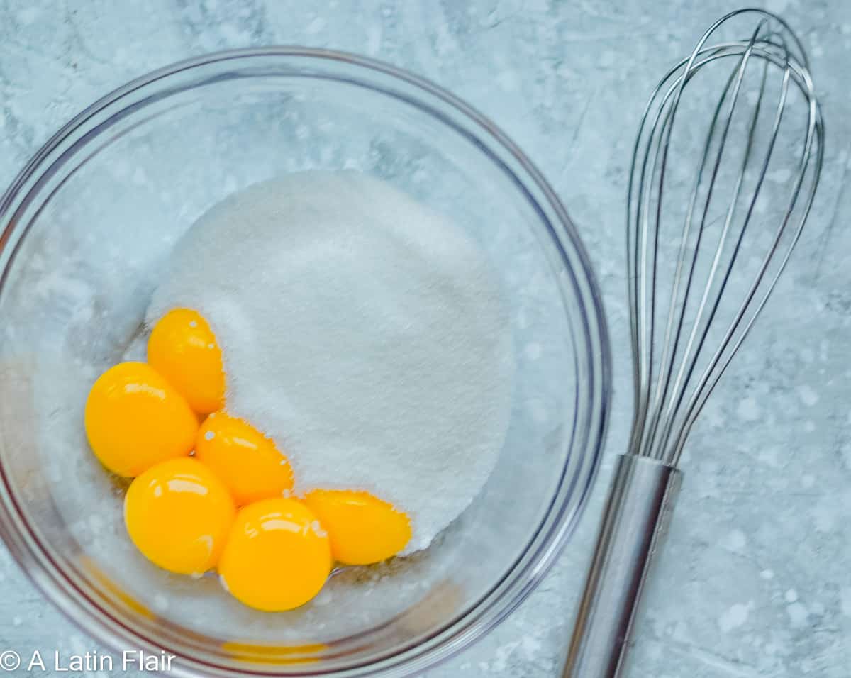 egg yolks and sugar in a glass bowl for chocolate marquesa