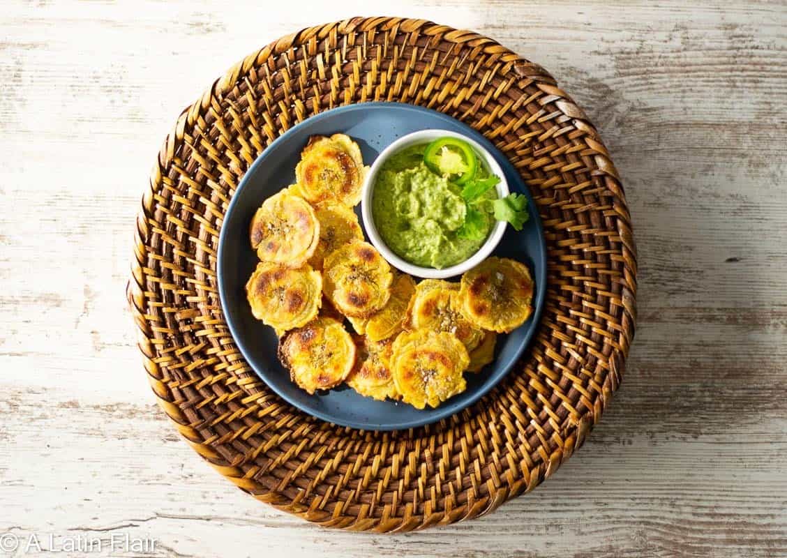 Oven-Baked-tostones-(Crispy-Baked-Green-Plantains)-on-blue-and-brown-plates