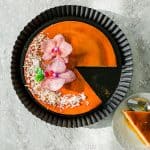 Coconut-Flan-(flan-de-coco)-with-flowers-and piece-cut-out