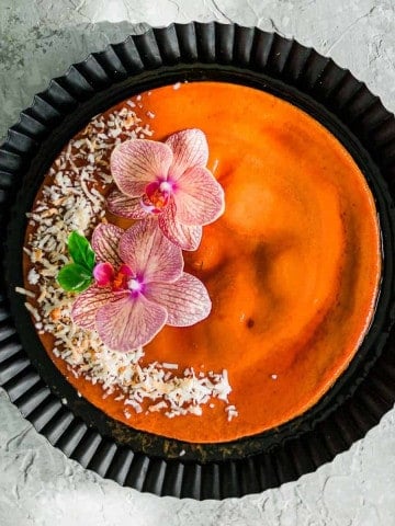 Coconut-Flan-over-black-dish-decorated-with-flowers