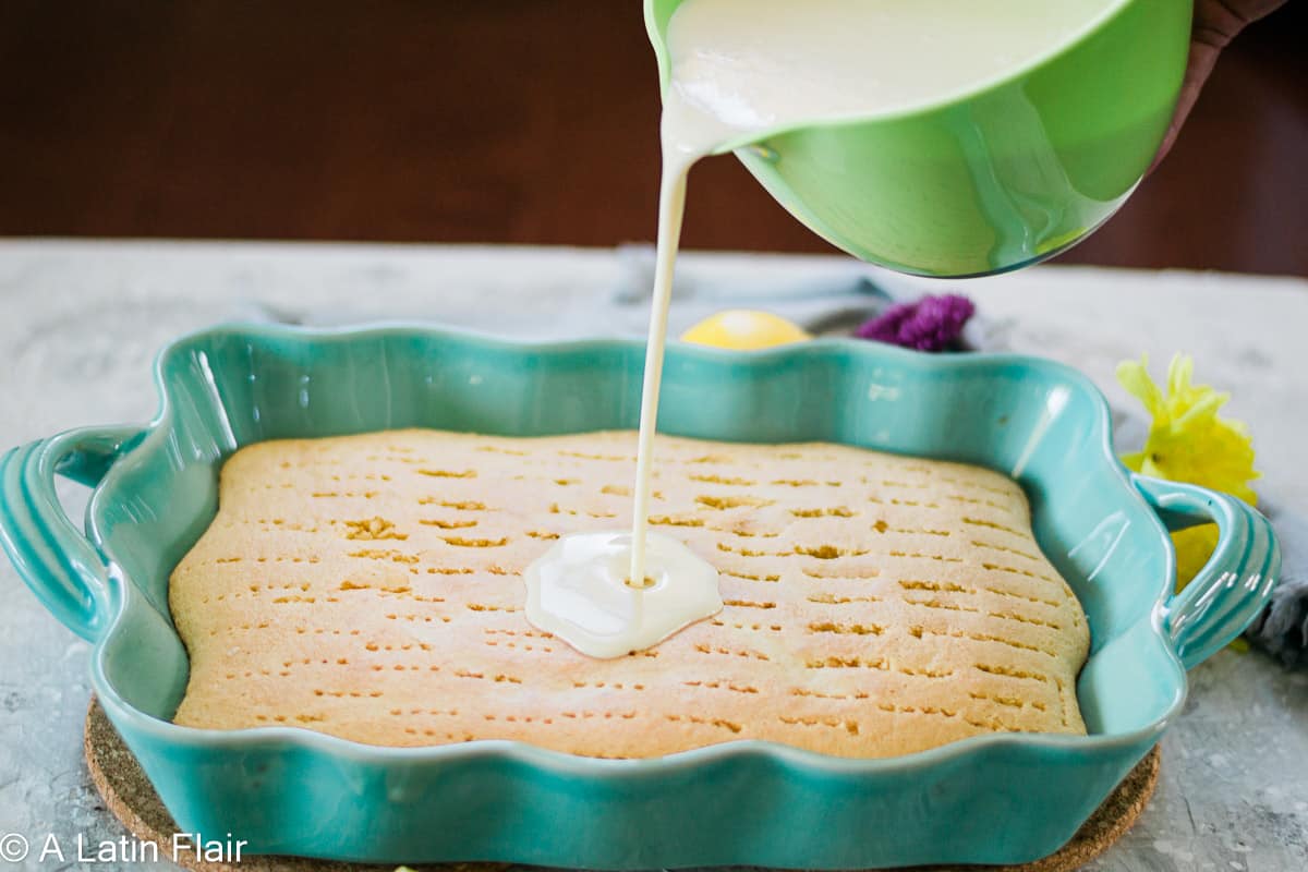 pouring-three-milks-mixture-over-lemon-tres-leches-cake