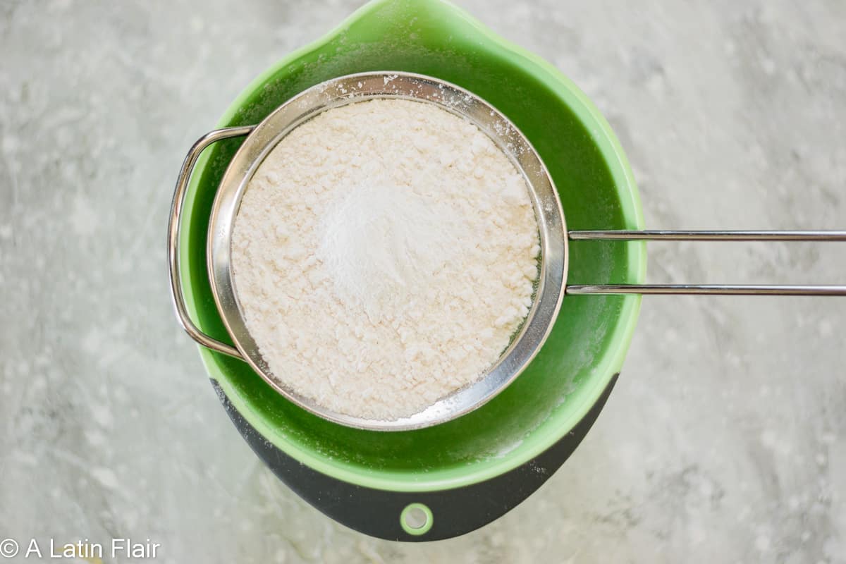 sifting-flour-for-tres-leches-cake