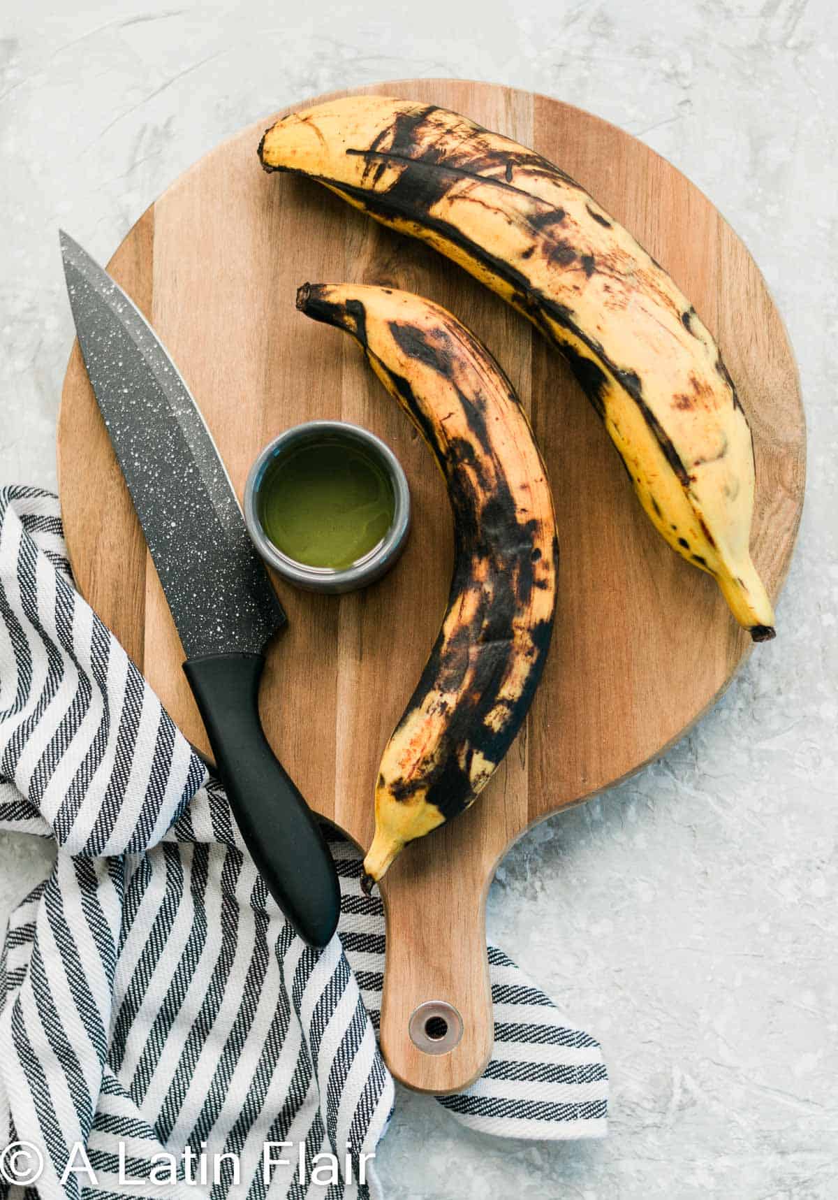 Just-Ripe-yellow-Plantains-with-black-spots-on-cutting-board