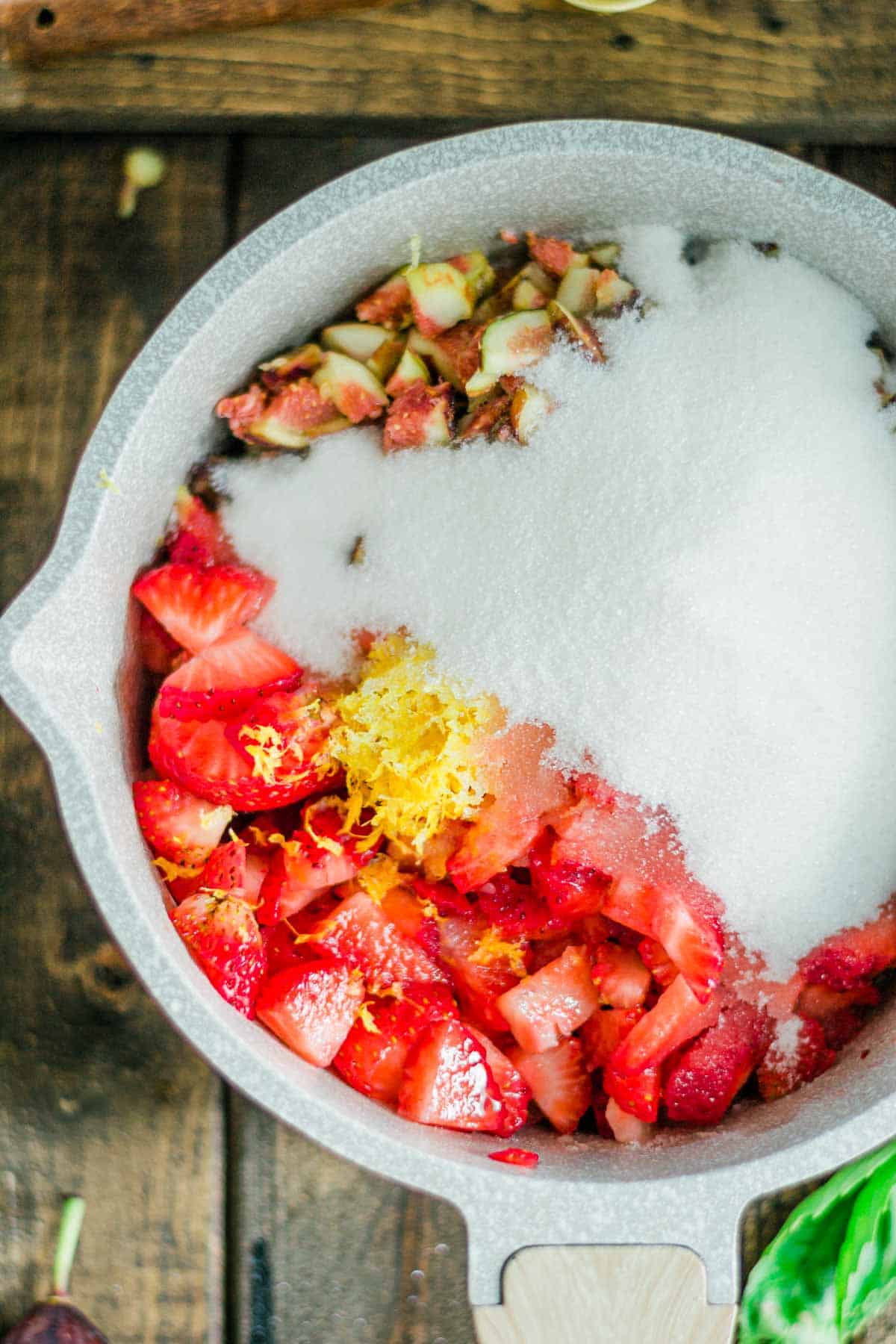 sugar-and-chopped-Strawberries-and-figs-in-saucepan-for-Strawberries-figs-preserves-recipe