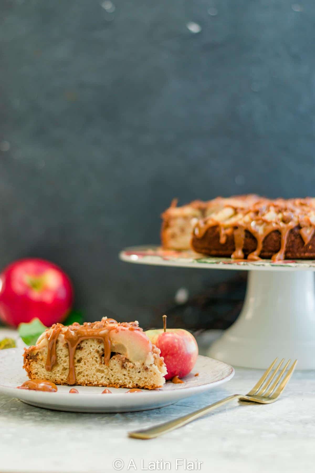 spiced-apple-streusel-cake-drizzled-with-dulce-de-leche-served-on-white-plate