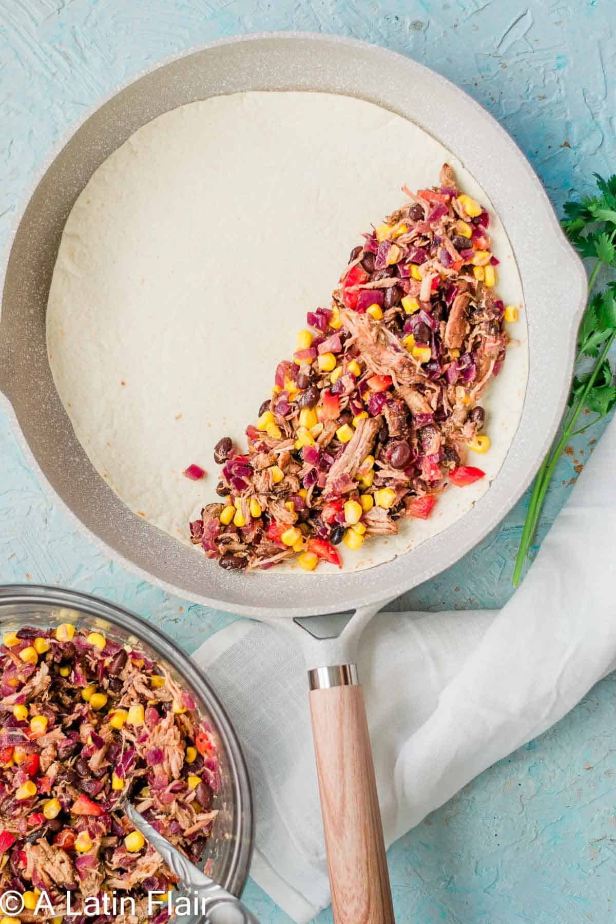 cooking quesadillas with leftover pulled Pork carnitas filling in a skillet 