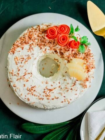 Carrot Cake with Pineapple and Coconut on white cake stand