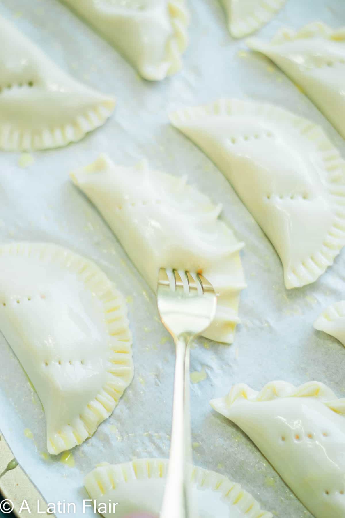 poking holes with a fork to apple empanadas