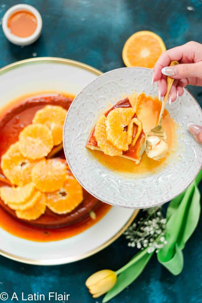 Orange Flan Recipe (Flan de queso recipe) served on small plate held by hands