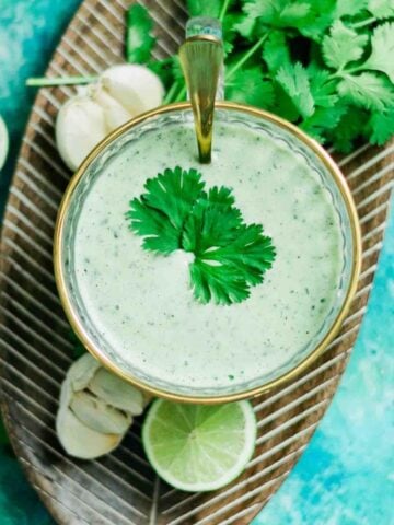 Spicy Garlic Cilantro Lime Sauce Recipe (Salsa de Ajo) in bowl over brown board