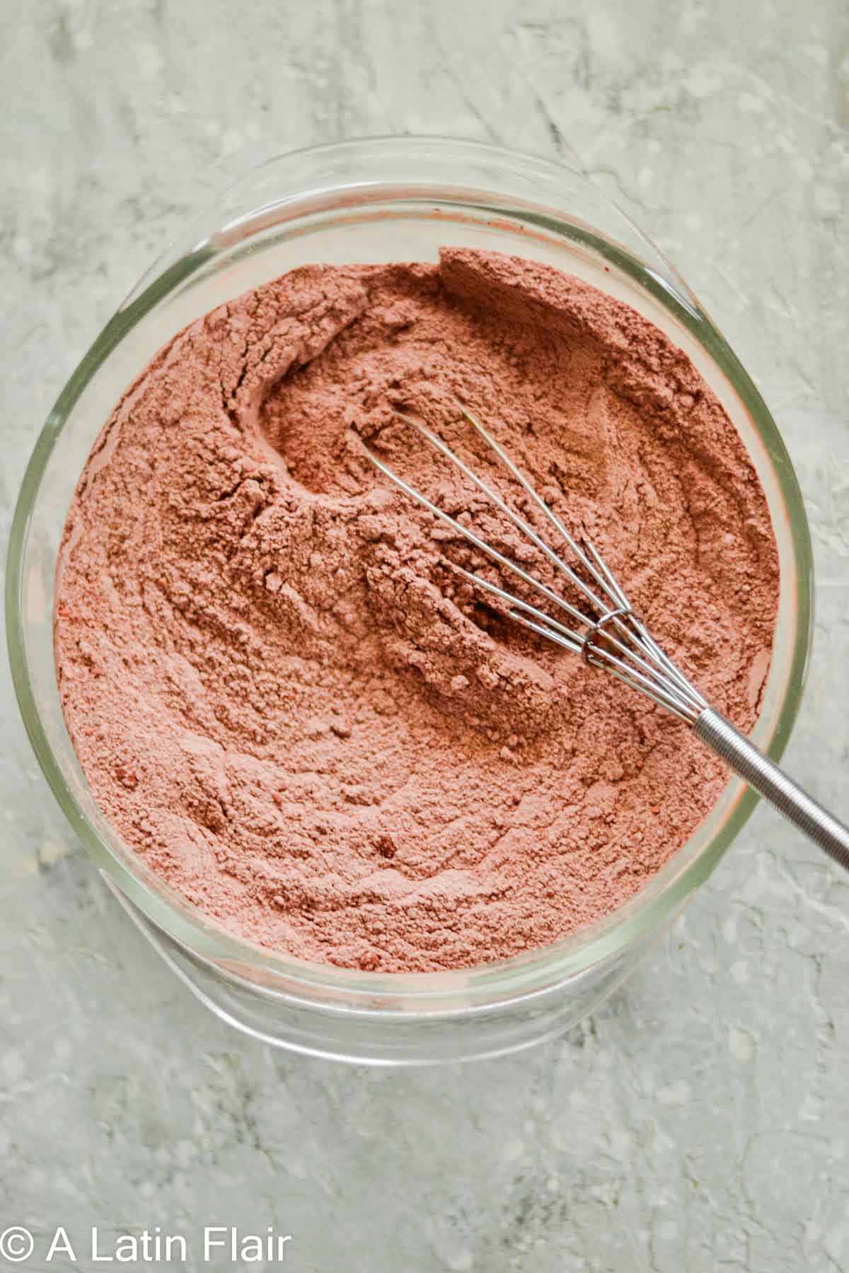 mixed dry ingredients in a bowl for chocolate cake with cream cheese filling