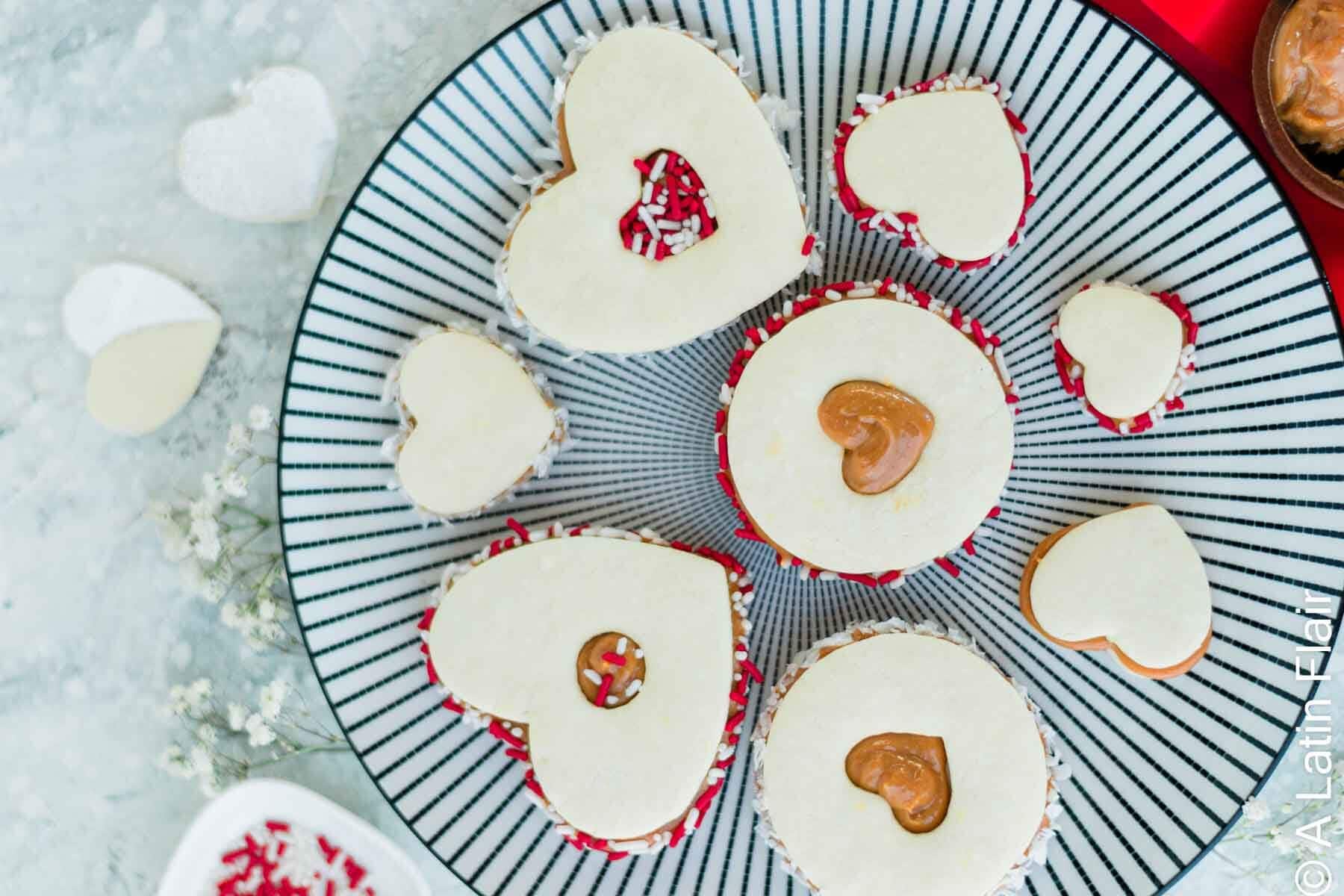 dulce de leche alfajores cookies on black and white plate