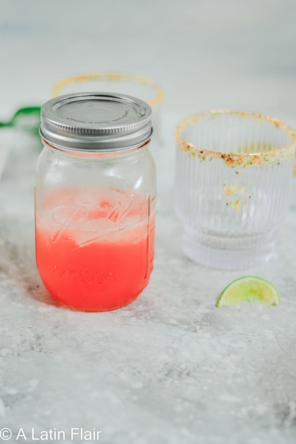 mixing aperol margarita in a mason jar