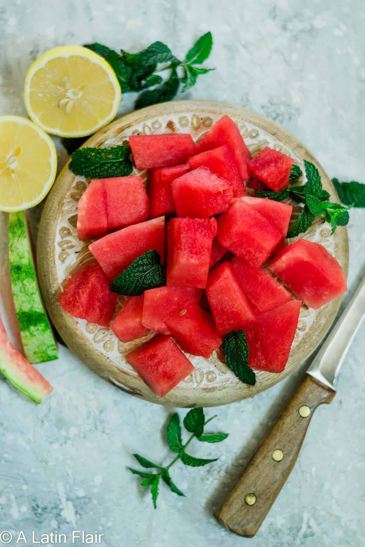 cut up watermelon cubes on cutting board for watermelon Agua Fresca