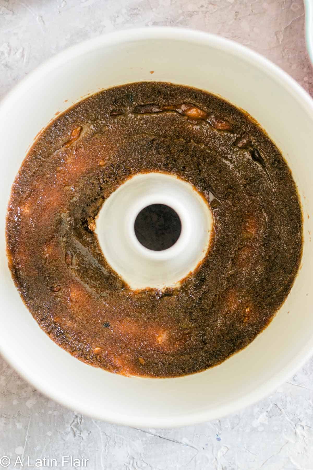 melted butter and brown sugar in cake pan for Upside Down Pineapple Rum Cake
