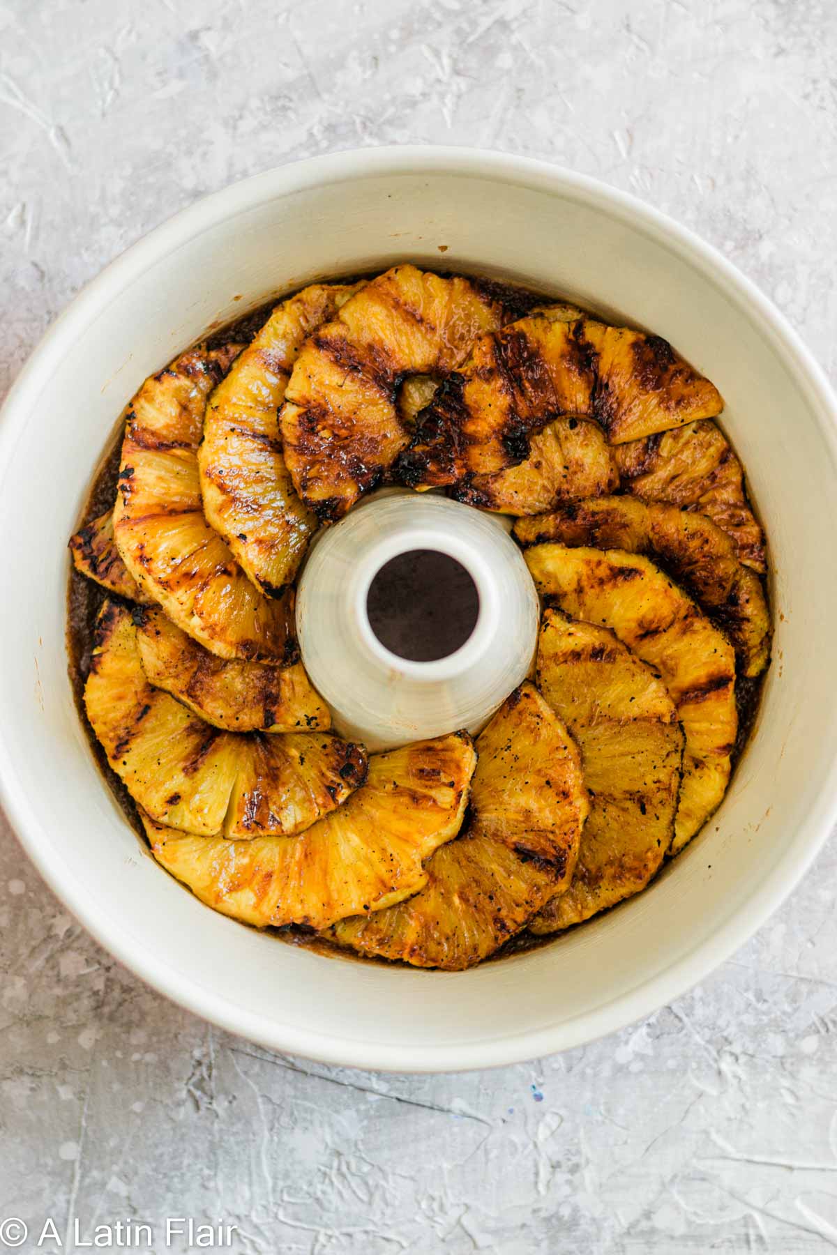 layered pineapple slices in cake pan for Upside Down Pineapple Rum Cake