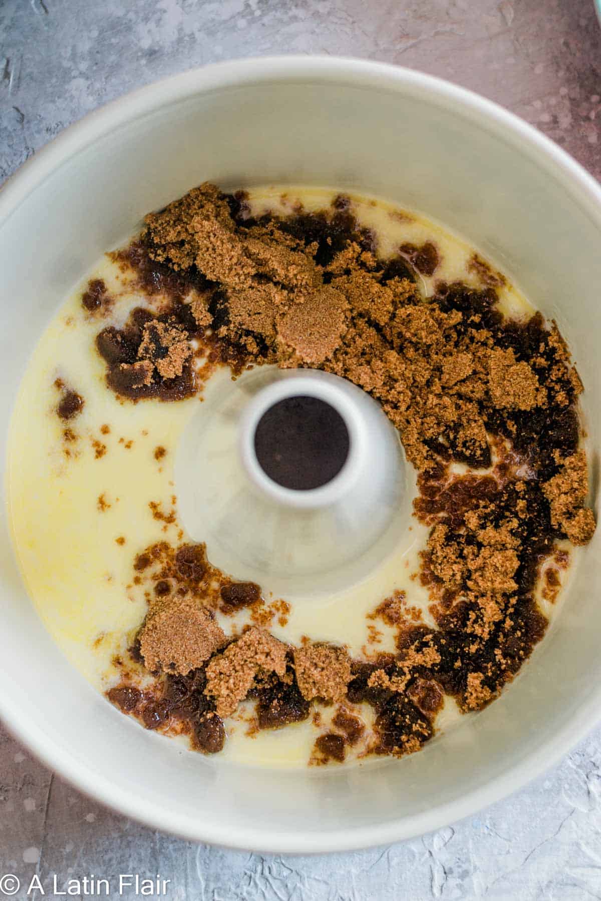 melted butter and brown sugar in cake pan for Upside Down Pineapple Rum Cake