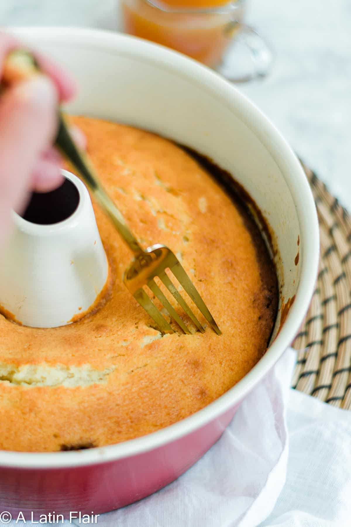 soaking cake with rum syrup for cuban rum cake