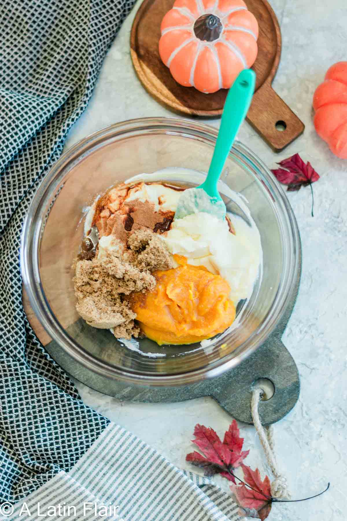 Mixing pumpkin tiramisu ingredients in glass bowl