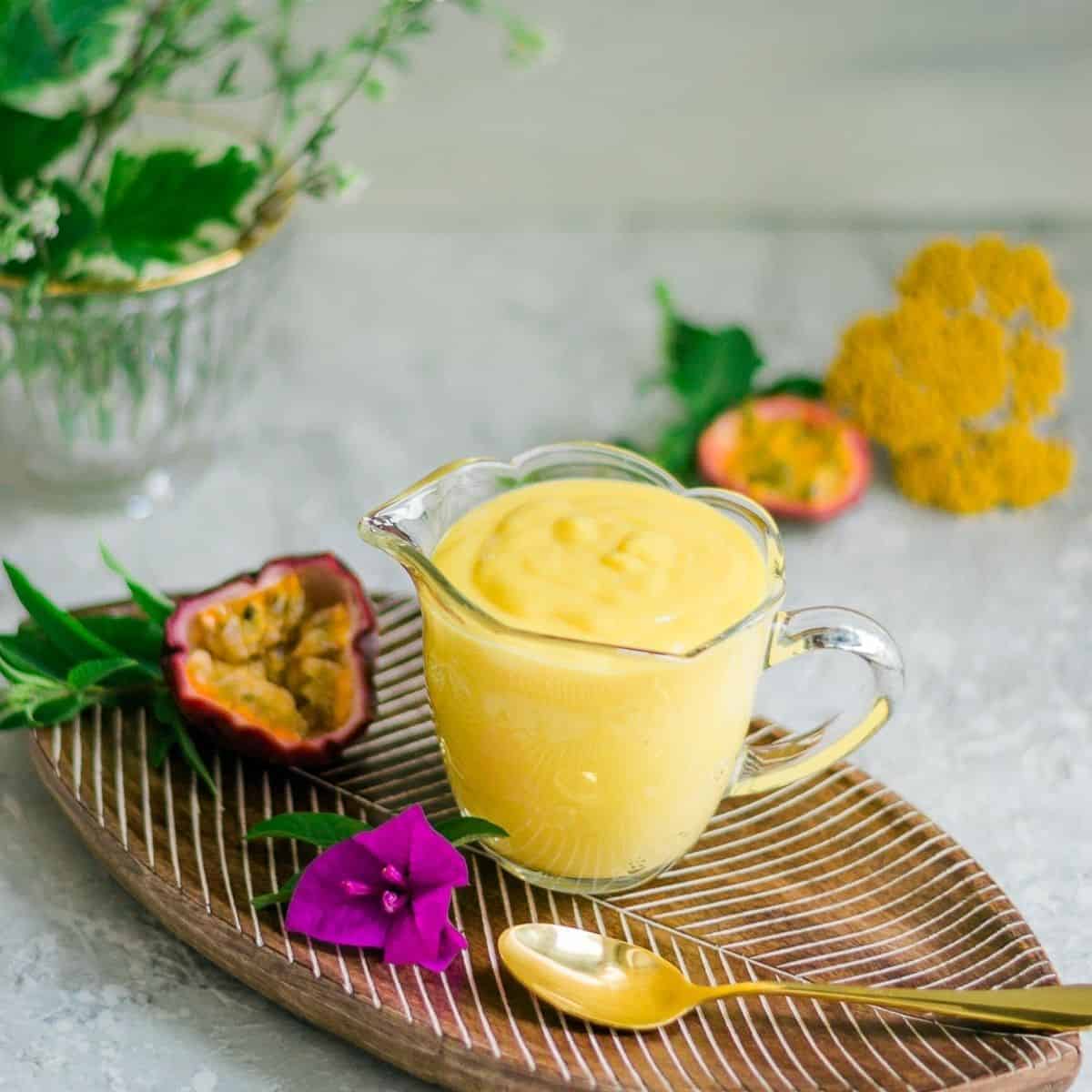 Passion fruit curd served in glass cup.