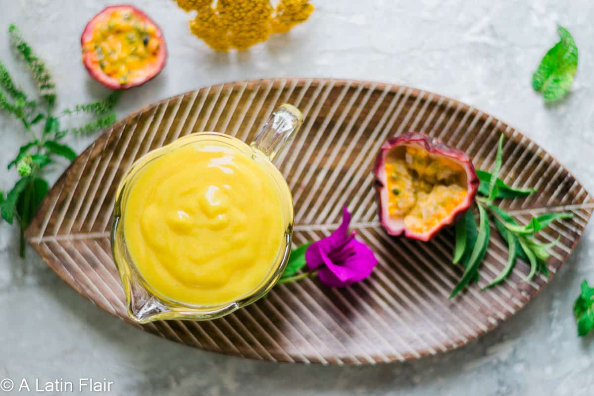 passion fruit curd in glass bowl over brown dish